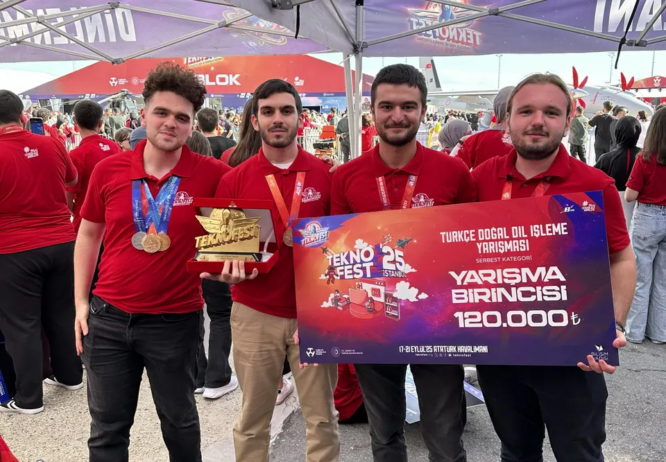 Four people in red shirts holding the TEKNOFEST trophy and a first-place sign for the Turkish natural language processing competition